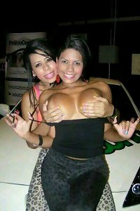 Voluptuous woman sensually licking her big breasts