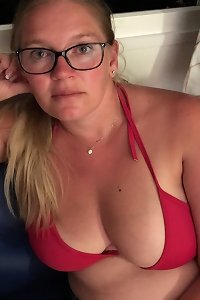 Voluptuous brunette seductively poses with eyes closed